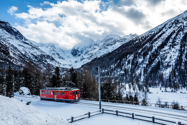 Lokomotive der Rhätischen Bahn bei der Montebellokurve oberhalb der Station Morteratsch bei Pontresina. Im Hintergrund das Bergpanorama der Berninagru